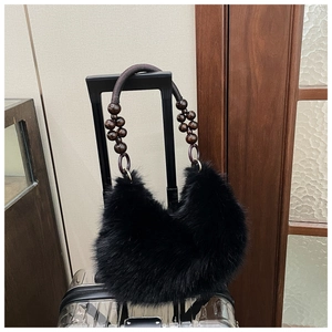 Detailed close-up of plush faux fur handbag featuring vintage dark wooden bead handles