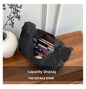 Detailed interior view of a black grid canvas tote showing its spacious storage capacity