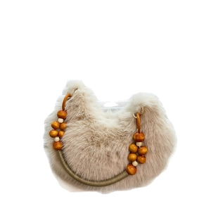 Beige plush handbag with stylish orange wooden bead handle on a clean white background