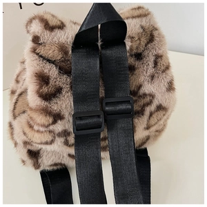 Detail of faux fur leopard backpack with adjustable black nylon straps and soft texture