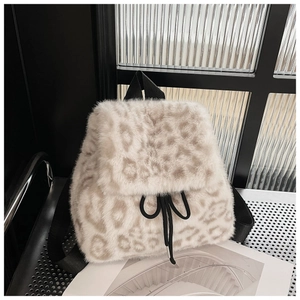 Detail of plush leopard print backpack with soft faux fur texture and drawstring closure