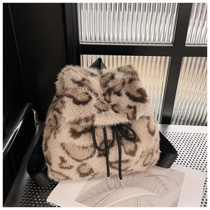Detailed view of leopard print faux fur backpack with drawstring closure and fabric straps