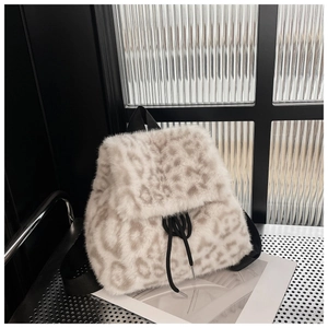 Close-up of leopard print plush backpack with black drawstring and soft faux fur texture
