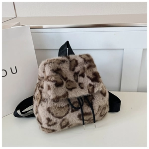 Macro detail of plush leopard print faux fur texture and drawstring closure on backpack