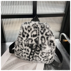 Macro shot of snow leopard print plush drawstring backpack texture and woven strap detail