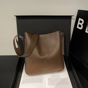 Minimalist brown leather tote bag with shoulder strap in premium gift box setting