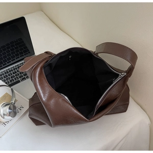 Detail view of large dark brown retro PU leather tote bag with inner zipper pocket