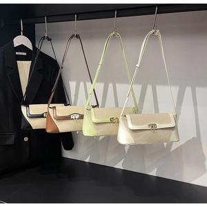Detail of four color-block canvas and PU leather crossbody bags with metal horseshoe clasps