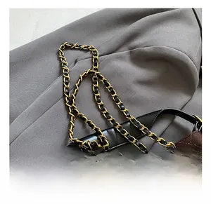 Detailed macro view of vintage brown suede quilted bag with gold chain and metal lock