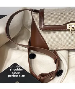 Detail of adjustable leather strap and golden horse-shoe buckle on vintage crossbody bag
