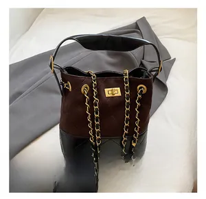 Detail of vintage contrast tote showing quilted suede stitching and golden chain strap