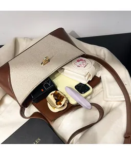 Detailed interior view of a contrast panel crossbody bag showing large storage capacity