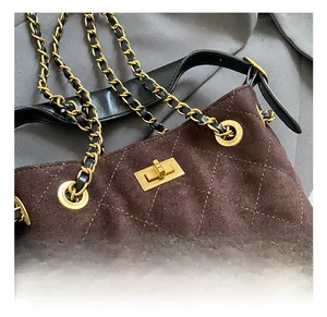 Detail of golden twist lock and quilted suede texture on the vintage bucket bag
