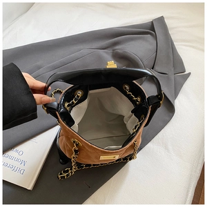 Top view of quilted suede bucket bag interior with metallic chain and spacious lining