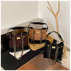 Three bucket bags in coffee, tan, and black with quilted patterns and gold chains
