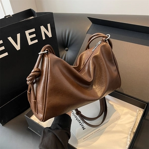 Classic dark brown Boston bag with smooth leather finish and decorative side knot detail