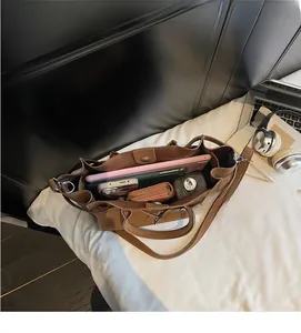 Internal view showing large storage capacity of brown faux leather shoulder tote bag