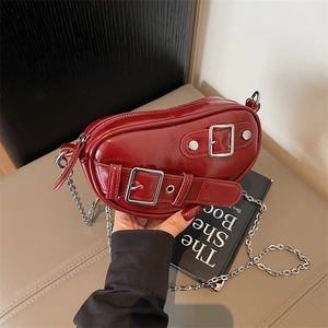 Sac bandoulière tendance en cuir verni bordeaux avec chaîne argentée et boucle métallique