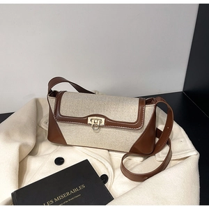 Detailed close-up of retro color-block crossbody bag with golden buckle and canvas texture
