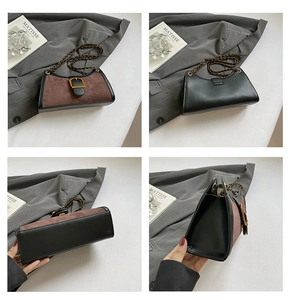Detail view of vintage baguette bag featuring color-block suede, leather, and gold buckle