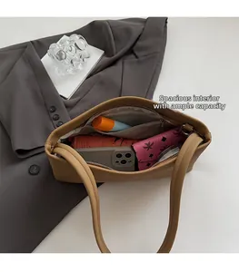Spacious interior of brown canvas underarm bag showing room for phone and wallet