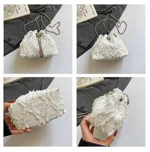 Macro detail of white denim bucket bag featuring frayed lattice and silver chain strap