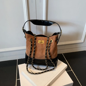 Brown suede and black leather quilted bucket bag with gold chain strap and turn-lock
