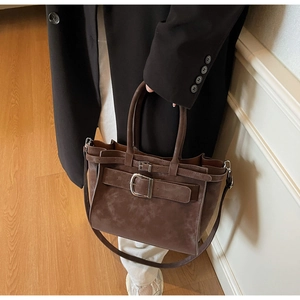 Retro coffee brown suede shoulder bag with strap buckle and structured trapezoid shape