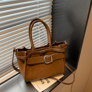Caramel brown vintage underarm bag featuring silver buckle detail and matte leather finish