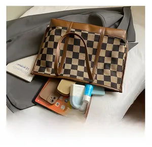 Detail view of large checkered tote bag interior showing ample capacity for tablets