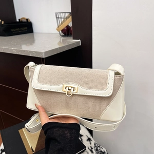 Chic cream canvas and leather patchwork shoulder bag with a vintage gold twist lock