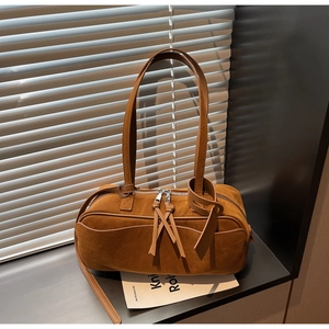 Detailed texture of caramel suede surface with metal zipper and long leather pullers