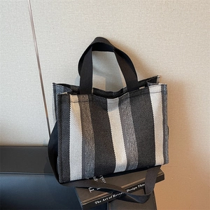 Large striped canvas tote bag with black shoulder strap for daily commuting and fashion