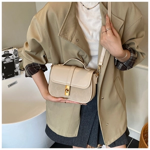 Detail of light beige crossbody bag with premium suede splicing and gold twist lock