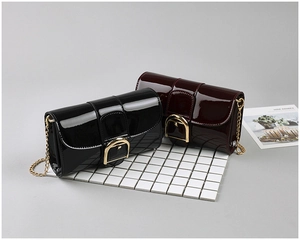 Détails de sacs en cuir verni brillant avec boucles dorées et bandoulières en chaîne