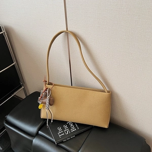 Mustard yellow vintage baguette shoulder bag with braided strap and smiley face charm
