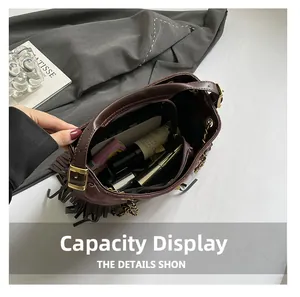 Top view of spacious interior storage for suede fringe shoulder bag with daily essentials