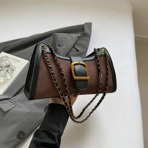 Brown suede and black leather baguette bag with large gold buckle and chain strap
