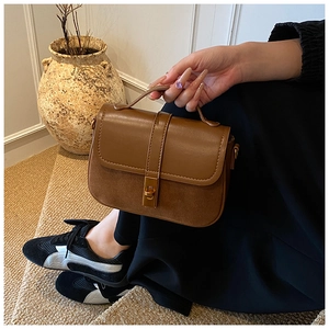 Detail of vintage brown shoulder bag showing contrasting PU leather and suede textures