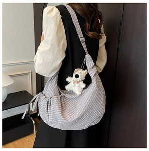 Detail of grey gingham dumpling bag with drawstring and cute white bear charm