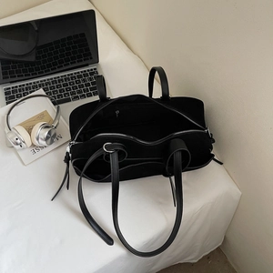 Interior detail of a black matte bowling bag with spacious zip pocket and suede lining