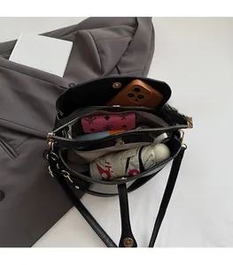 Interior view of black pebbled leather tote showing multi-compartment storage space