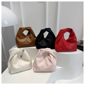 Detail showing various colors of ruched cloud bags with unique knotted single handle