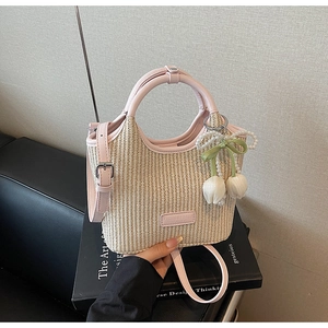 Details von rosa Lederbesatz und Strohgeflecht mit floralem Perlenanhänger