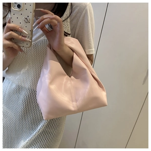 Detail view of pink knot handbag with soft pleated PU leather and minimalist design