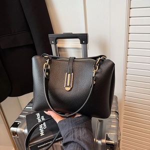Chic black lychee grain leather tote bag with gold chain strap and metal lock detail