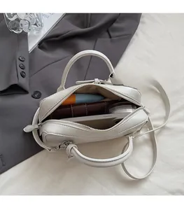 Interior view of the cream Boston bag showing capacity for phone, wallet and cosmetics