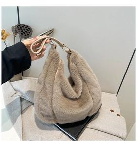 Detailed close-up of faux fur tote bag with golden metal rings and smooth leather handle