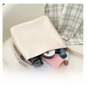 Large cream-colored bucket bag showing spacious interior with daily essentials