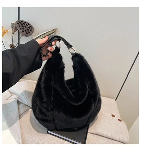 Close-up of black faux fur hobo bag with leather handle and silver metal rings